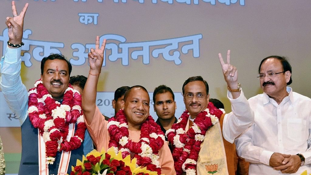 BJPs Yogi Adityanath (C) elected leader of the BJP Legislature Party (Chief Minister Uttar Pradesh) K P Muriya (L Deputy CM) and Dinesh Sharma (R Deputy CM) showing victory sign after the meeting in Lucknow on Saturday. (Photo: PTI)