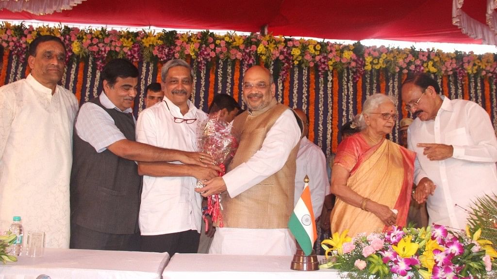 BJP chief Amit Shah and senior leader Nitin Gadkari greet newly sworned in Goa Chief Minister Manohar Parrikar during his swearing in ceremony at Raj Bhavan.