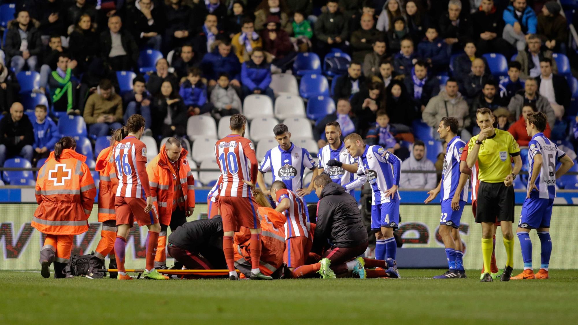Paramedics and players  gather around Atletico Madrid’s Fernando Torres as he lies injured on the ground. (Photo: Reuters)