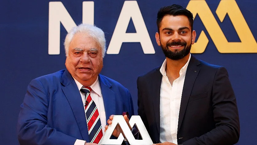 Virat Kohli receives the Polly Umrigar Award from Farokh Engineer. 