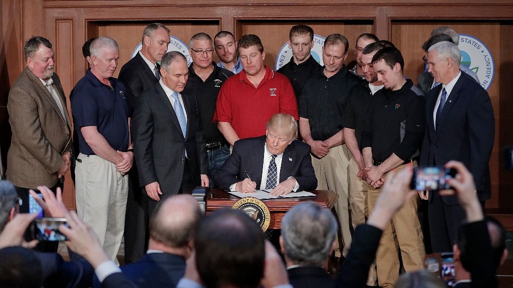 Trump signed an executive order aimed at moving forward on his campaign pledge to unravel former President Barack Obama’s plan to curb global warming. (Photo: AP)