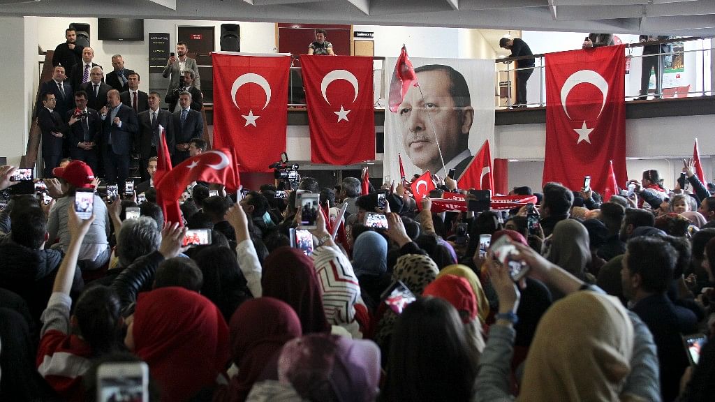 The pictures of Turkey’s President Recep Tayyip Erdogan hangs on a balustrade among Turkish flags. (Photo: AP)