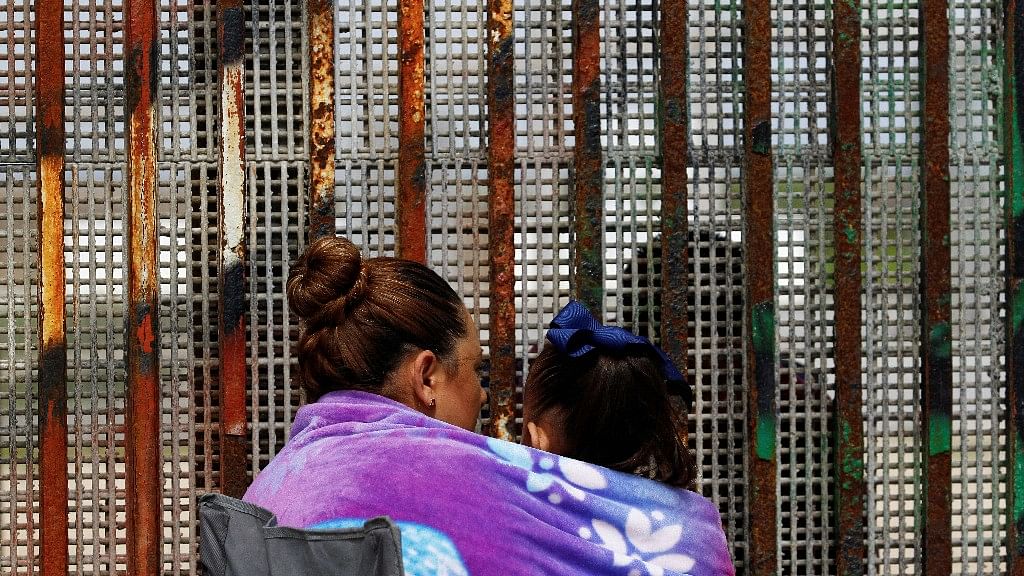 A woman talks to her husband across the fence separating Mexico and US, in  Tijuana, Mexico on March 4 2017. (Photo: Reuters)