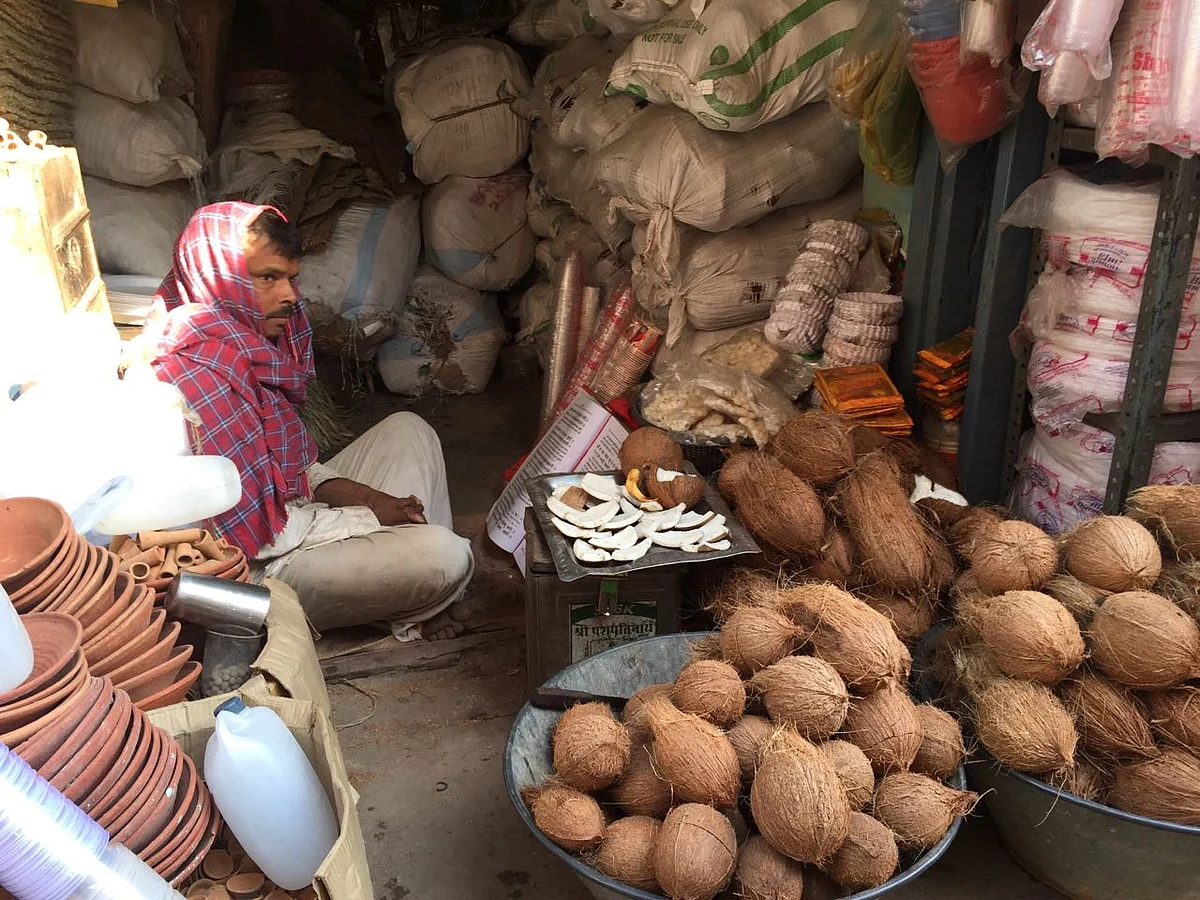 A coconut seller reading religious texts. (Photo: Jyoti Malhotra)