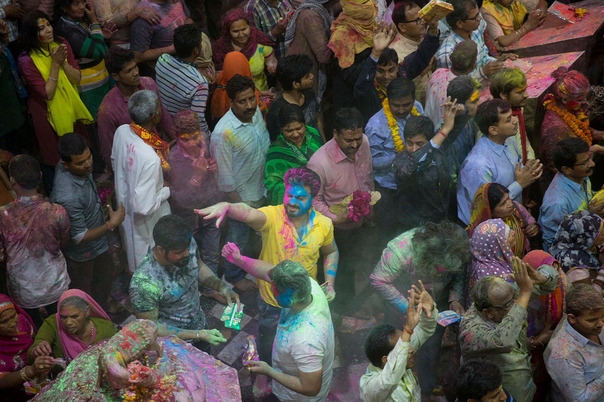 Hindu devotees throw colored powders on each other inside Banke Bihari temple during Holi festival celebrations in Vrindavanon March 8, 2017. (Photo: AP)