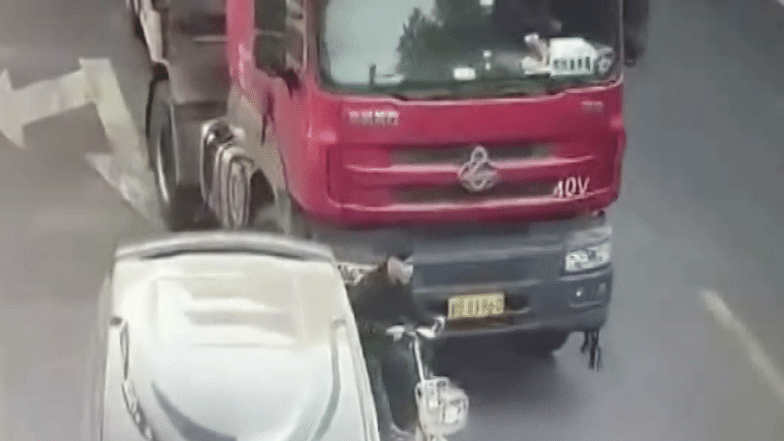 Cyclist gets knocked down by a truck ( Photo Courtesy- AP video Grab)