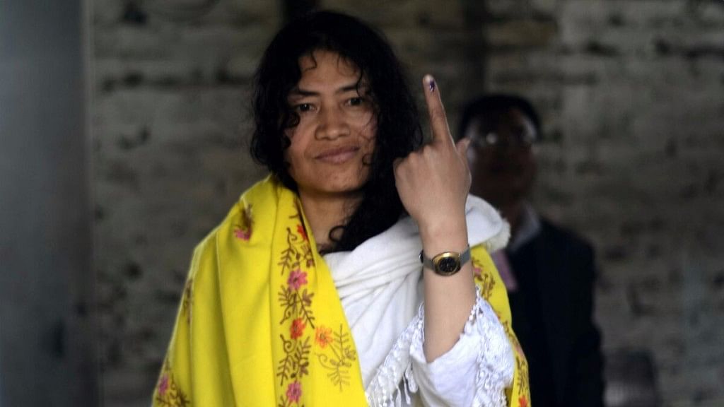 Manipuri rights activist Irom Sharmila shows her forefinger marked with phosphorus ink after casting her vote.  (Photo: IANS)