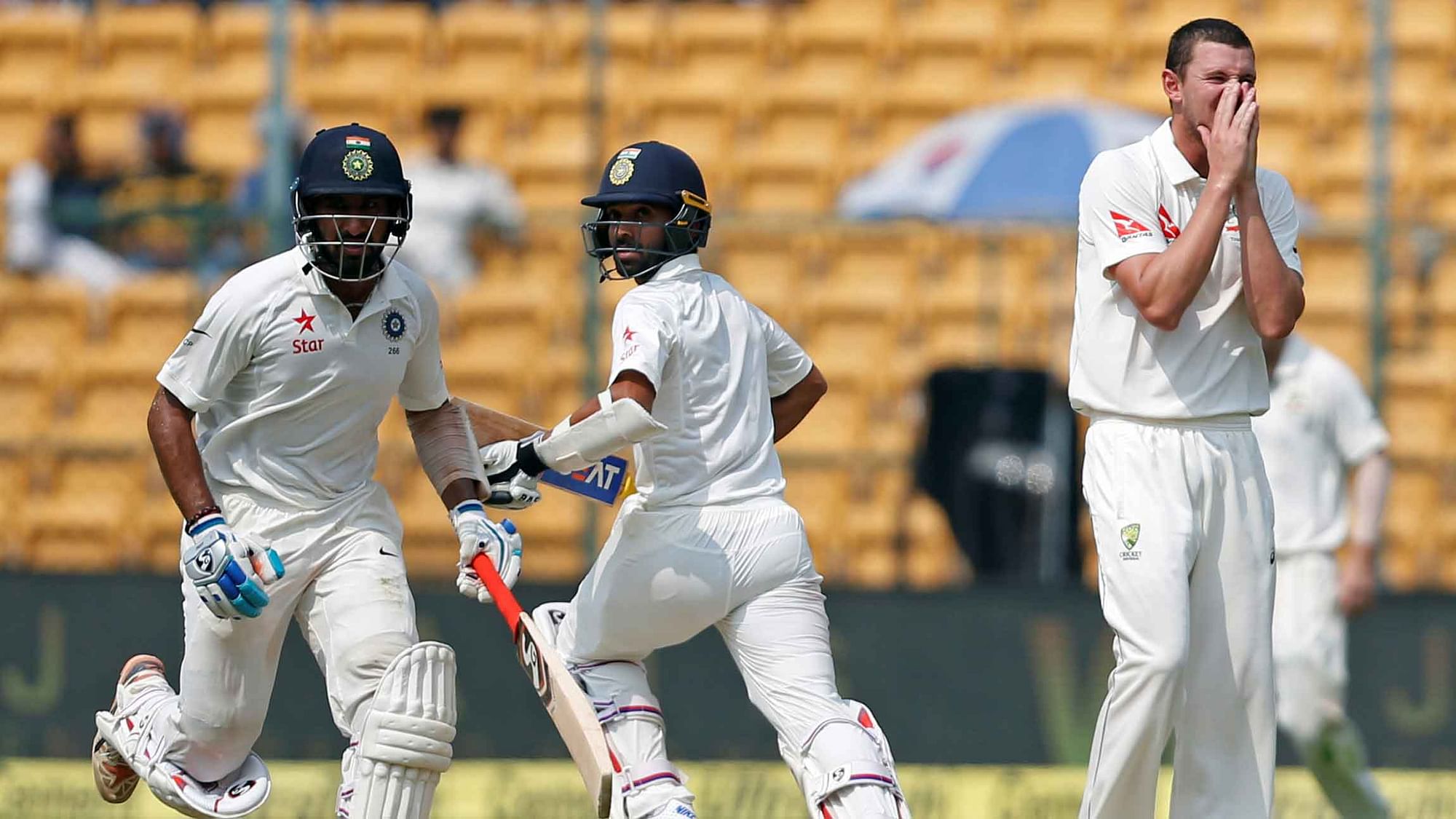 India’s Cheteshwar Pujara and Ajinkya Rahane run between the wickets as Australia’s Josh Hazlewood looks on during the third day of the second Test between India and Australia (Photo: Reuters)