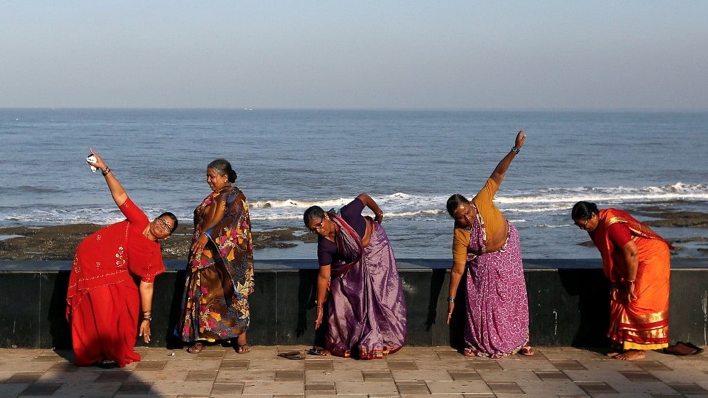 Traditionally dressed  women exercise on a promenade along the Arabian Sea in Mumbai. (Photo: Reuters/Danish Siddiqui)