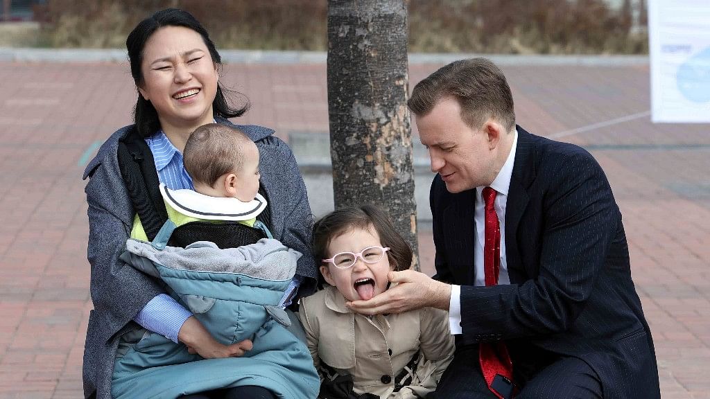 Robert Kelly, professor at Pusan National University, waits for a press conference with his wife Jung-a Kim and children James and Marion. (Photo: AP)