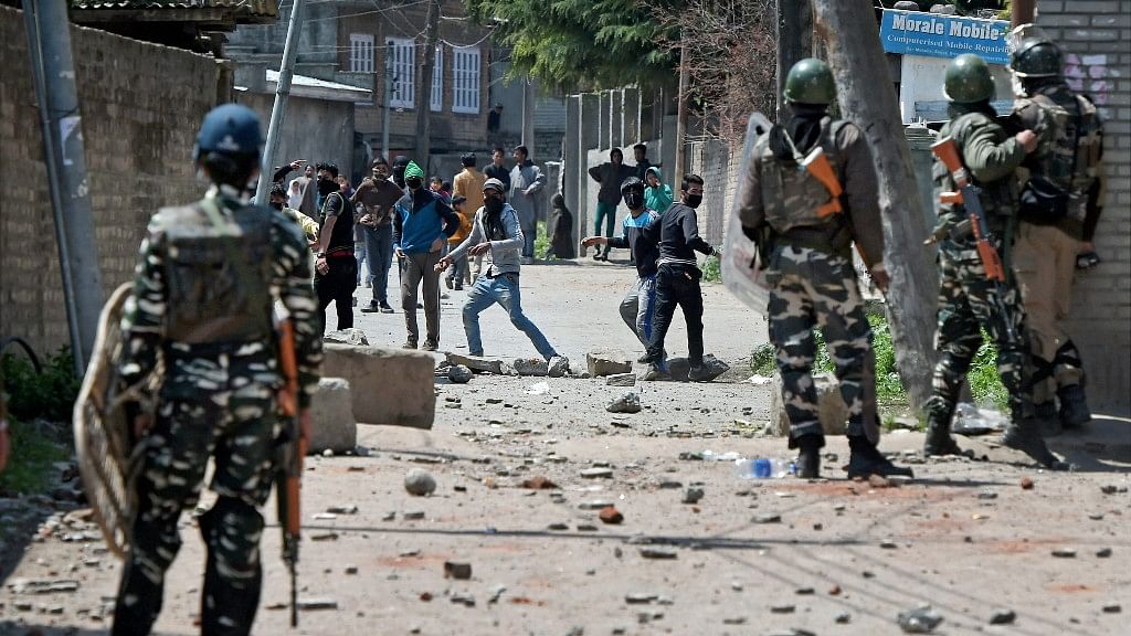 Youngsters throw stones on Security forces during clashes in Srinagar on Sunday. (Photo: PTI)