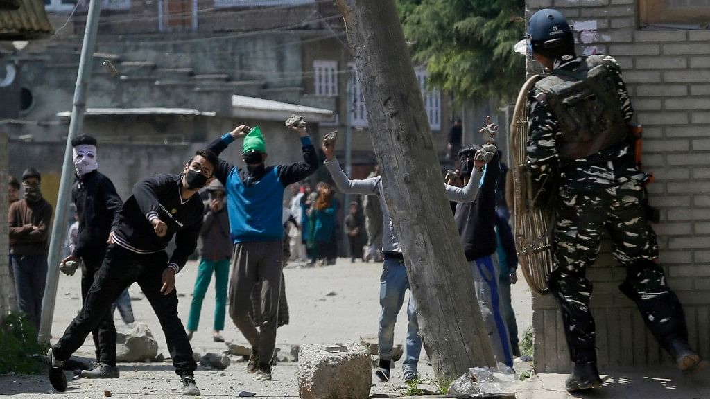Kashmiri protesters throw stones on Indian security personnel  during a by-election to the Lok Sabha seat in Srinagar (Photo: AP)