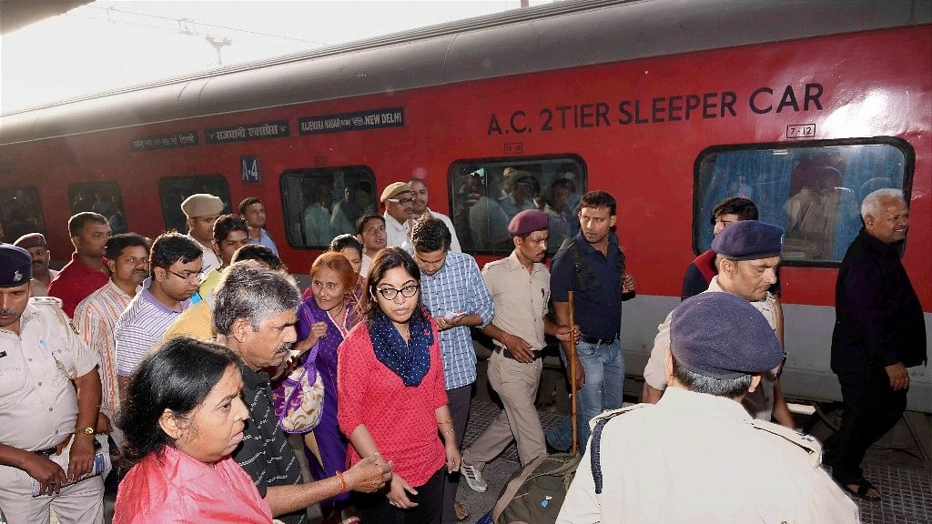 Distressed passengers disembark at Patna Railway Station on Sunday. (Photo: PTI)