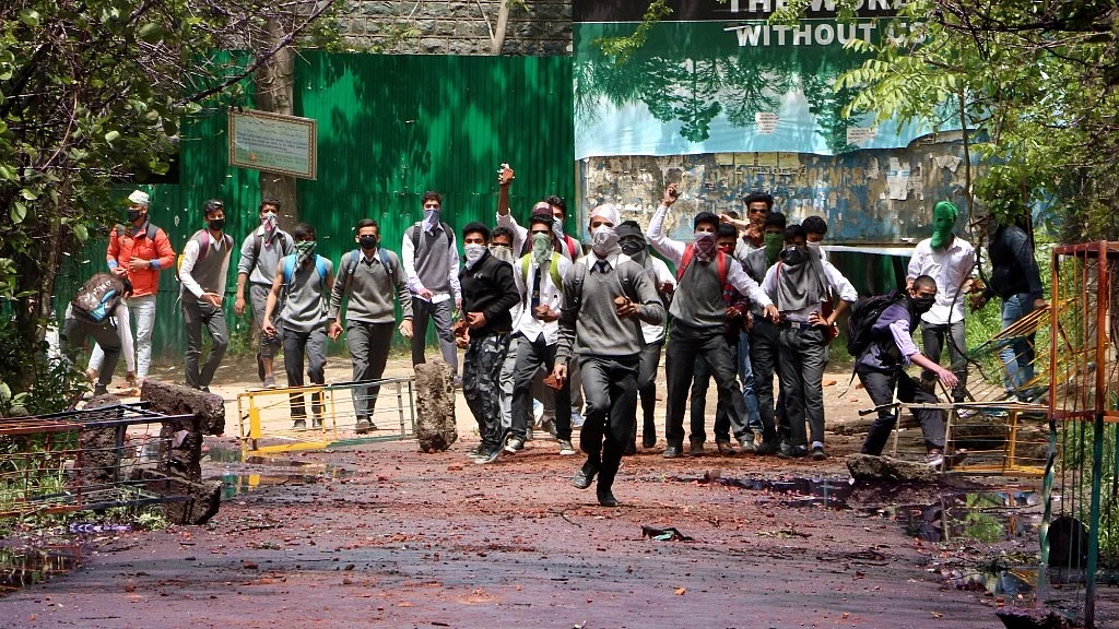 Students pelt stones at security personnel in Srinagar on 24 April 2017. (Photo: IANS)