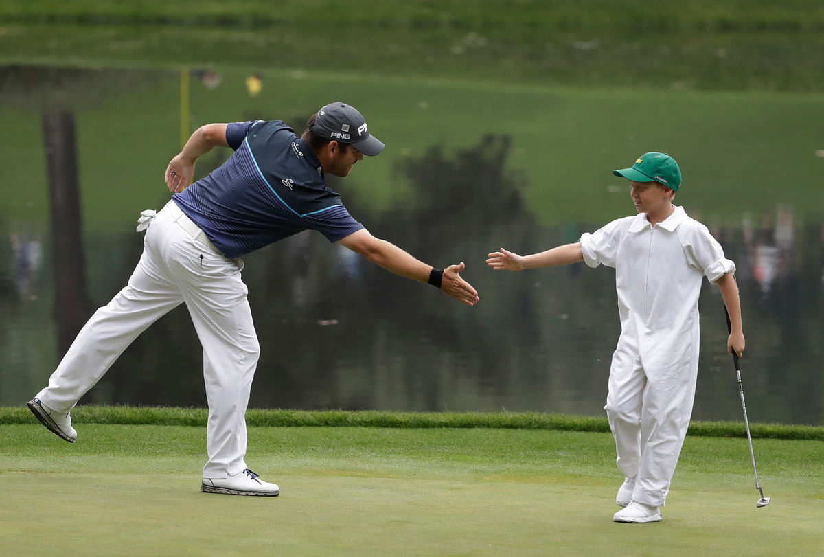 Weather played spoilsport during the Par 3 Contest, but the golfers managed to get on the course with their kids.