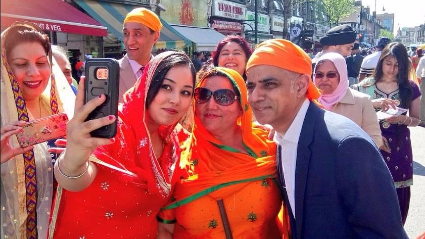 Sadiq Khan poses for selfies at the Baisakhi parade in Southall, London. (Photo Courtesy: Twitter/<a href="https://twitter.com/SadiqKhan">@SadiqKhan</a>)