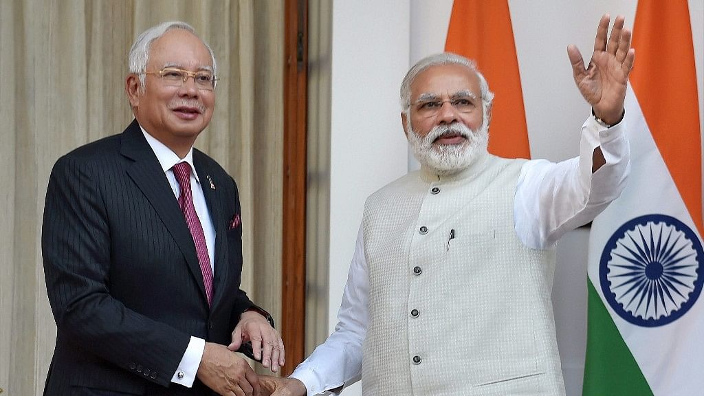 Prime Minister Narendra Modi greets his Malaysian counterpart Najib Razak in New Delhi on Saturday. (Photo: PTI) 