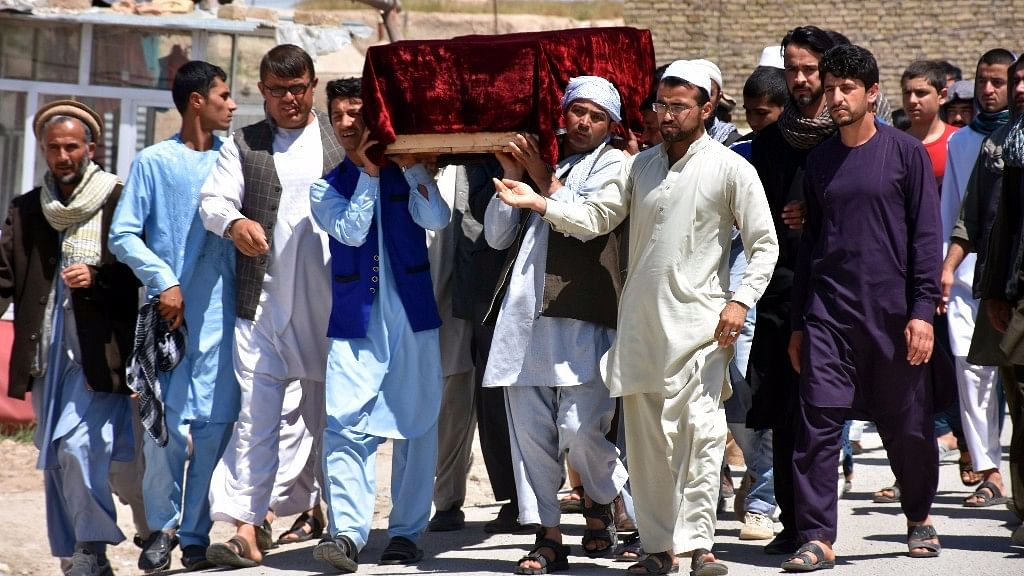 Men carry the coffin of one of the victims after Friday’s attack at a military compound in Mazar-e-Sharif province north of Kabul, Afghanistan, on 22 April. (Photo: AP)