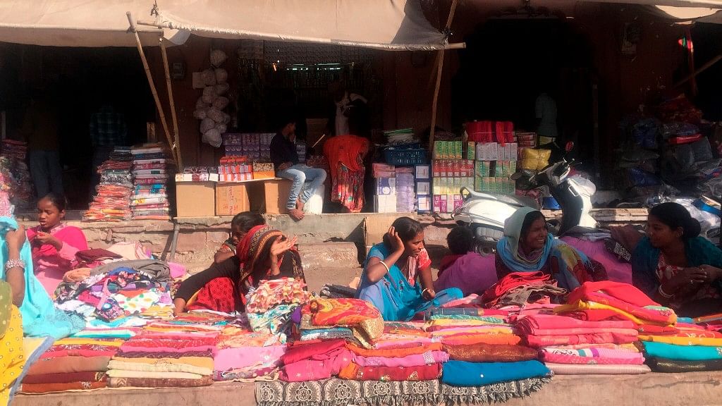 Women sell brightly coloured textiles in Jodhpur. India’s colorful and complex culture was highlighted in a month-long cross-country trip by an American woman traveling solo, who found she was sometimes as much an object of curiosity to locals as they were to her. (Kristi Eaton via AP)<a></a>