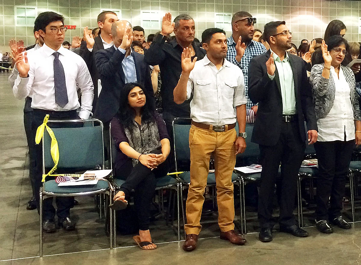 Indian-born U.S. national cricket team player Timil Kaushik Patel, second from left, takes an oath as a naturalized U.S. citizen at a ceremony in Los Angeles, Tuesday, April 18, 2017. His wife Pooja Patel is seated, left. (Photo: AP)