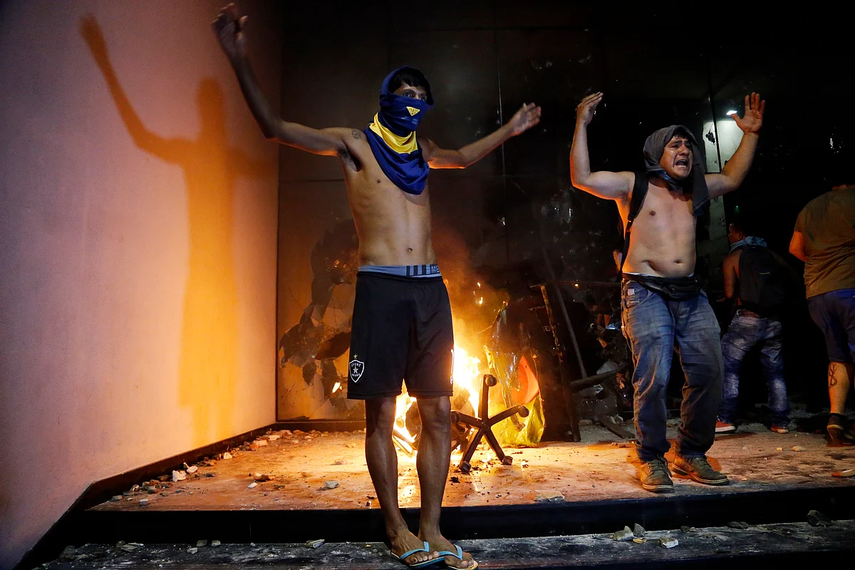 Some protesters broke through police lines and entered the first floor, where they set fire to papers and furniture. (Photo: AP)