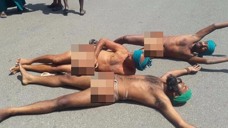 Protesting Tamil Nadu farmers roll naked on the road near the Prime Minister’s office in Delhi. (Photo Courtesy: The News Minute)