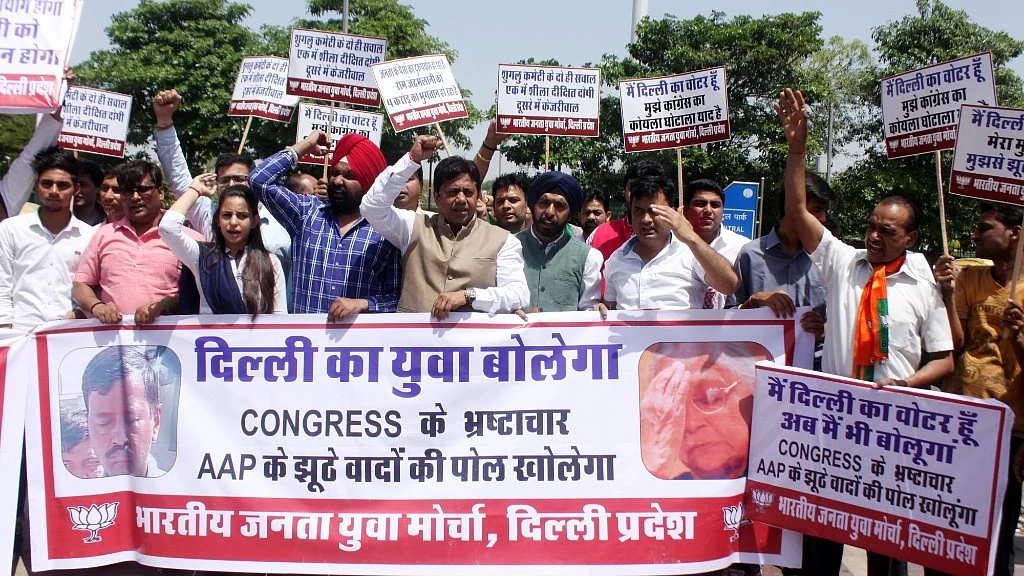 BJP Yuva Morcha activists stage a protest against Delhi Chief Minister Arvind Kejriwal and Congress in New Delhi on 11 April 2017. (Photo: IANS)