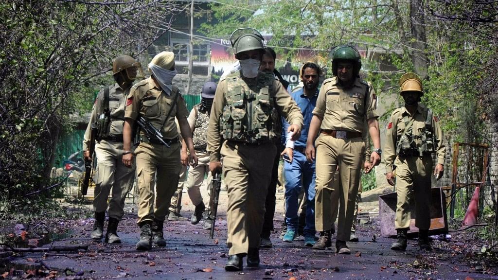 Police forces walking past stones pelted by students in J&amp;K. Representative image.