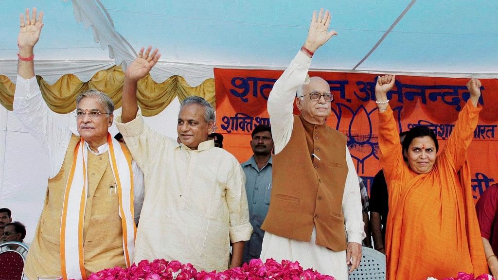 <i>(From left)</i> Murli Manohar Joshi, Kalyan Singh, LK Advani and Uma Bharti wave at the crowd at a public meeting after appearing in a special court in connection with the demolition of Ayodhya’s Babri Masjid, in Rae Bareilly, on 28 July, 2005. (Photo: PTI)