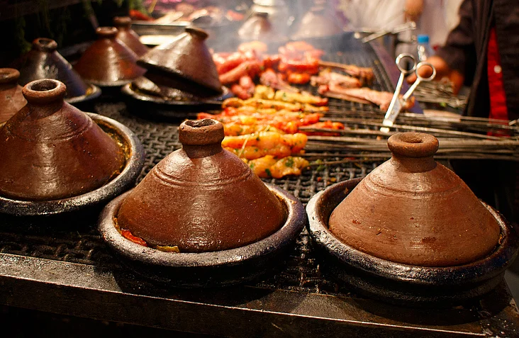 Tagines being prepared over charcoal fire. (Photo: iStock)