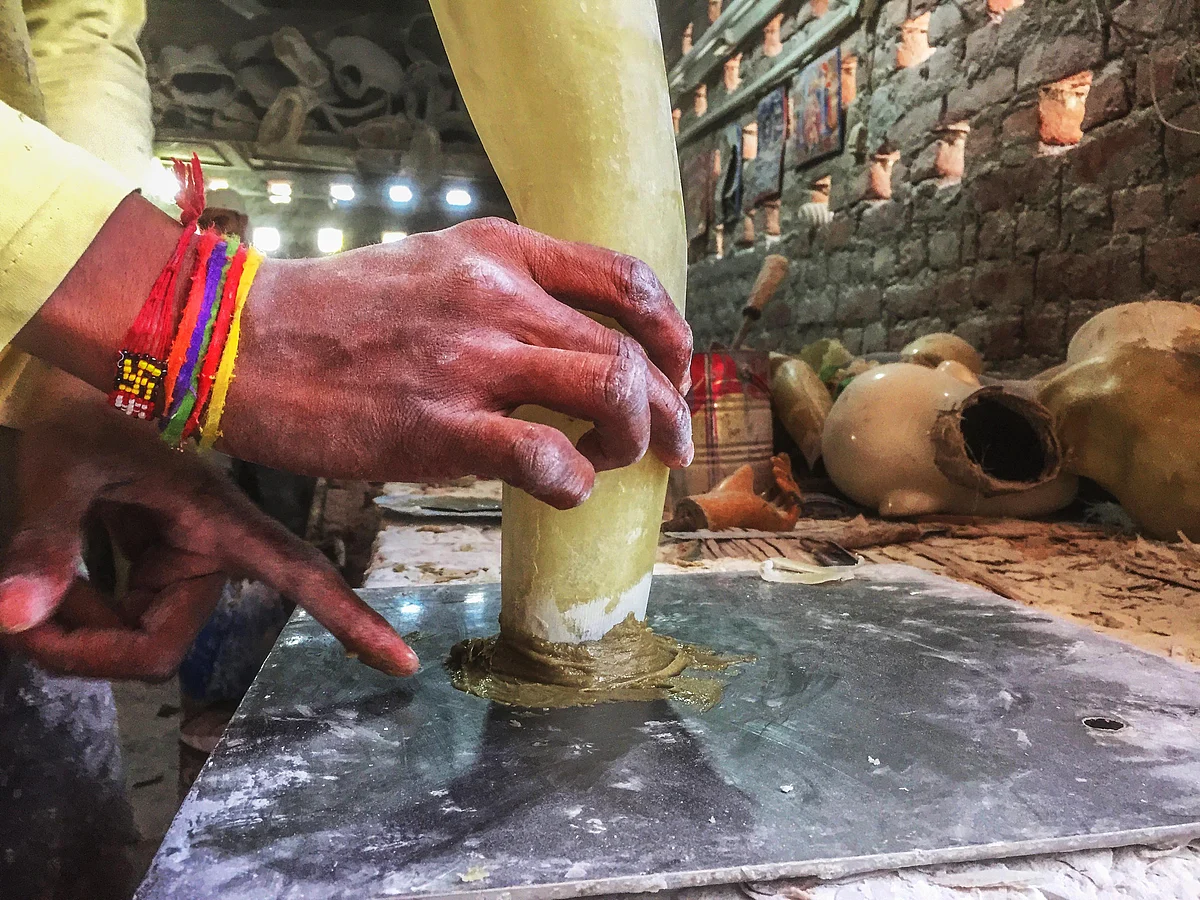 A worker fixing a mannequin hand at the factory. (Photo: Erum Gour/<b>The Quint</b>)