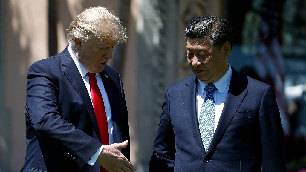 President Donald Trump and Chinese President Xi Jinping pause for photographs at Mar-a-Lago. (Photo: AP)