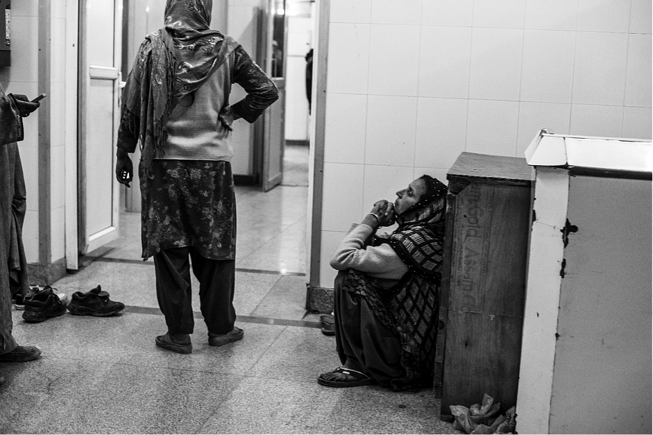 A woman waits outside an operation theatre for her injured son, who received pellet injuries during a protest in Budgam district of Kashmir. (Photo: Hashim Hakeem)