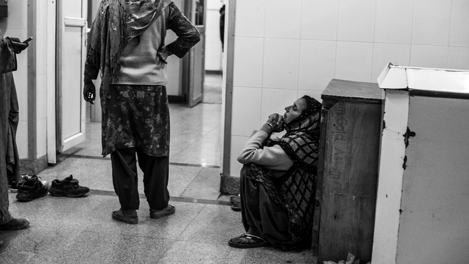 A woman waits outside an operation theatre for her injured son, who received pellet injuries during a protest in Budgam district of Kashmir. (Photo: Hashim Hakeem)