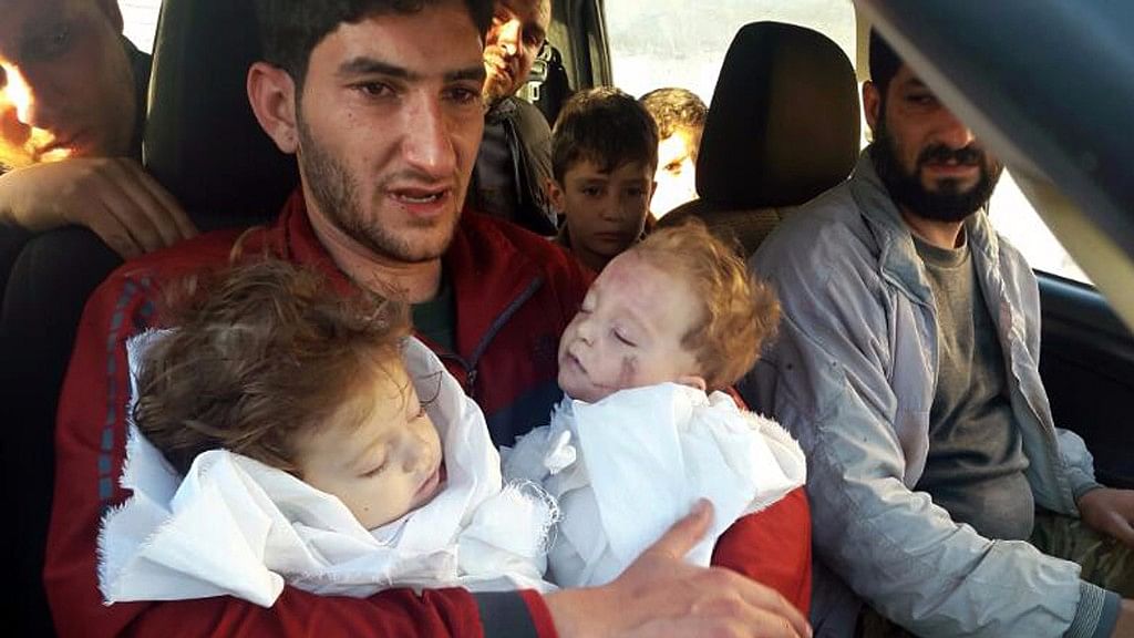 Abdul-Hamid Alyousef, 29, holds his twin babies who were killed during a suspected chemical weapons attack in Khan Sheikhoun, in the northern province of Idlib, Syria. (Photo: AP)