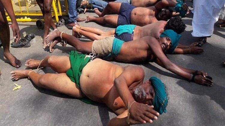 TN farmers roll on the ground in protest. (Photo Courtesy: The News Minute)