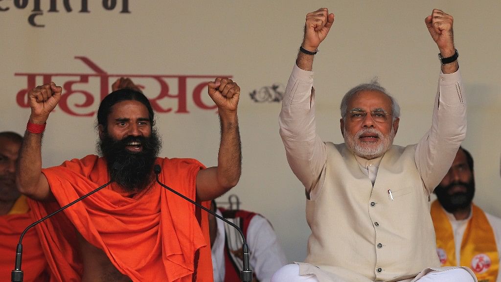 Baba Ramdev <i>(left)</i> with Prime Minister Narendra Modi (<i>right</i>) at a Yoga festival in New Delhi. (Photo: Reuters)
