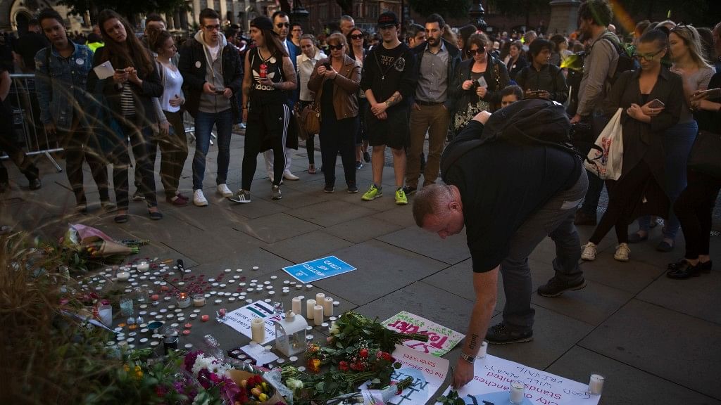

People lay flowers after a vigil in Manchester, England the day after the suicide attack. (Photo: AP)