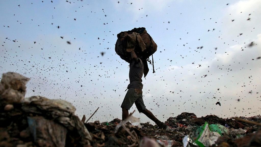 A ragpicker surrounded by flies in Mumbai . (Photo: Reuters)