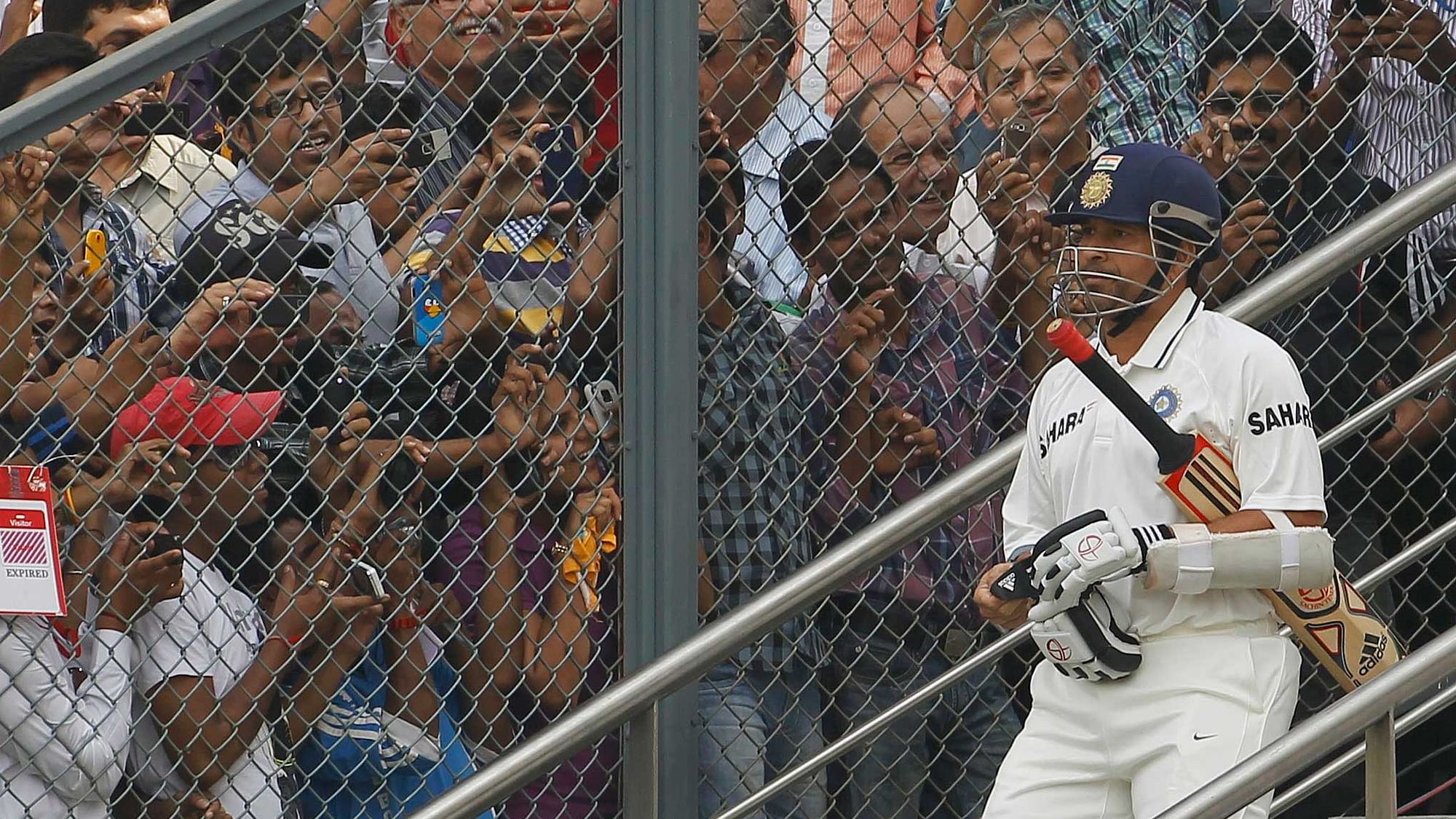 India’s Sachin Tendulkar arrives to bat as fans try to take pictures during the third day of their third test cricket match against West Indies in Mumbai November 24, 2011.&nbsp;