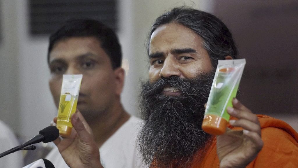  Patanjali Ayurved founders Swami Ramdev and Acharya Bal Krishna display the companys products at its annual press conference (Photo: PTI)