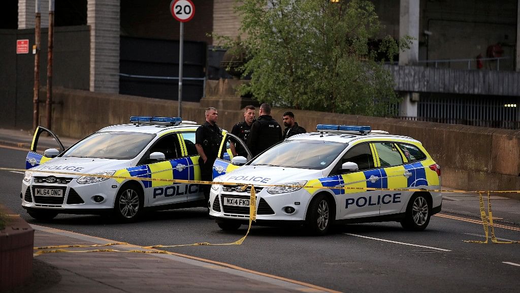 Police officers stand next to their vehicles near the Manchester Arena after a blast at Ariana Grande concert. (Photo: AP)