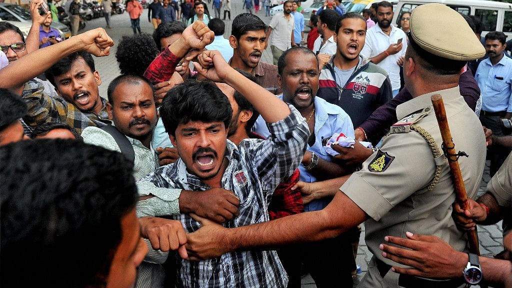 Police trying to control the members of SFI, DYFI shouting slogans against the proposed beef ban by the Central government, in Bengaluru on Monday. (Photo: PTI)&nbsp;