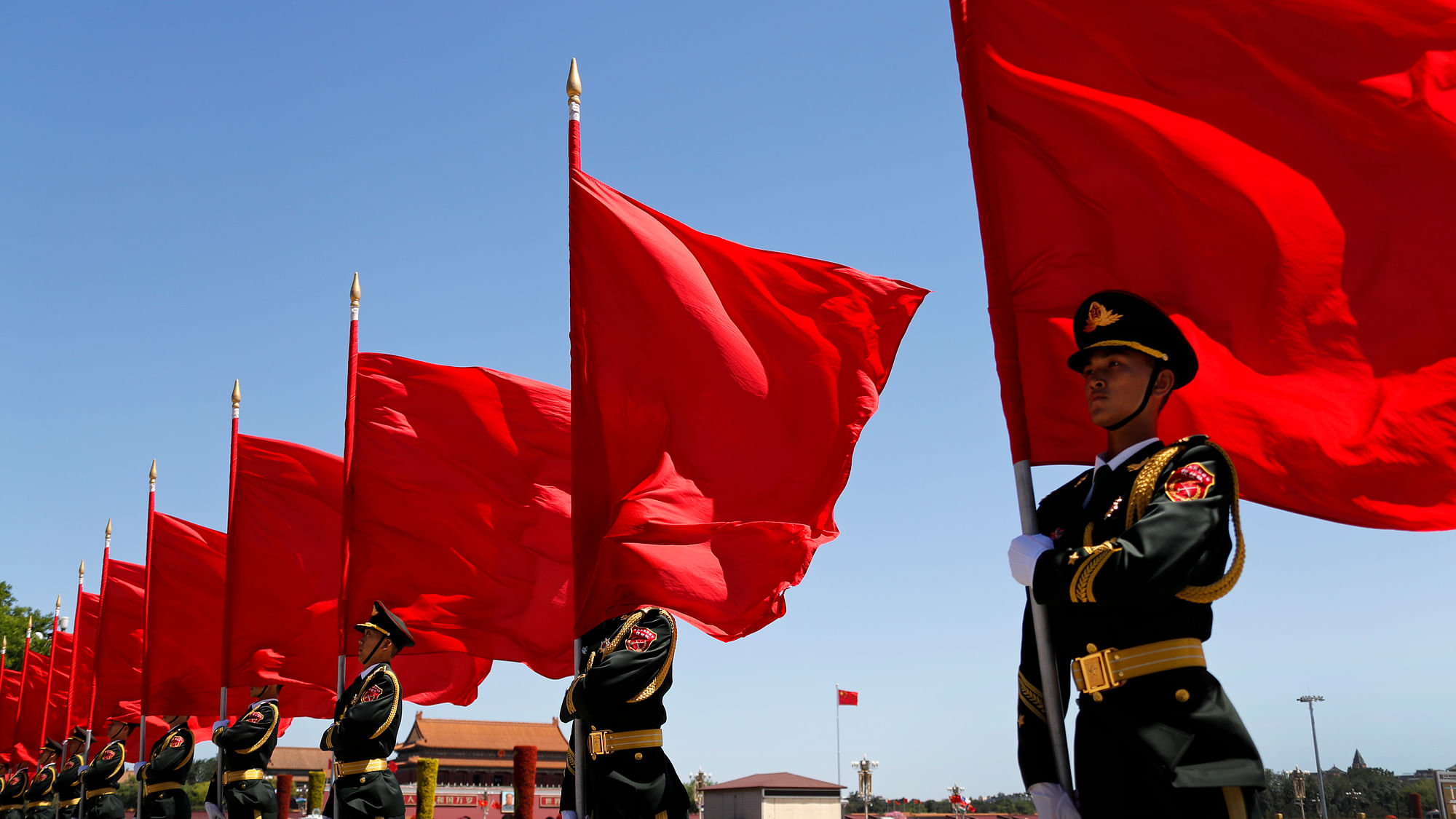 Members of the honour guard hold red flags as they wait for the arrival of VIPs during a welcome ceremony marking the the Belt and Road Forum outside the Great Hall of the People in Beijing, Saturday, 13 May 2017. (Photo: AP)<a></a>
