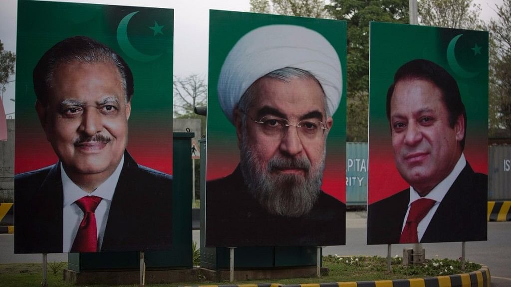 The hoarding of Iranian President Hassan Rouhani, center, is on display with Pakistan’s Prime Minister Nawaz Sharif, right, and President Mamnoon Hussain in Islamabad, Pakistan, March 2016. (Photo: AP)