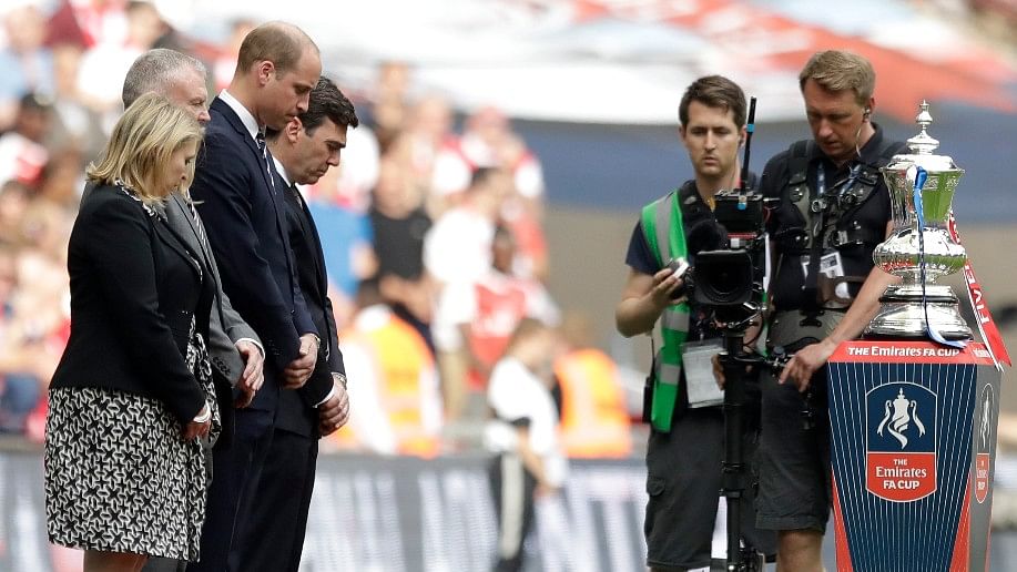 Britain’s Prince William, third from left, stands next to wreaths laid on the side of the pitch, as a tribute to the victims of the Manchester bomb attack before the FA Cup final between Arsenal and Chelsea. (Photo: AP)&nbsp;