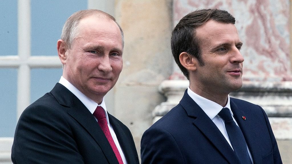 French President Emmanuel Macron, right, and his Russian counterpart Vladimir Putin visit an exhibition  at the Grand Trianon after a working meeting at the Versailles Palace near Paris on Monday. (Photo: AP)