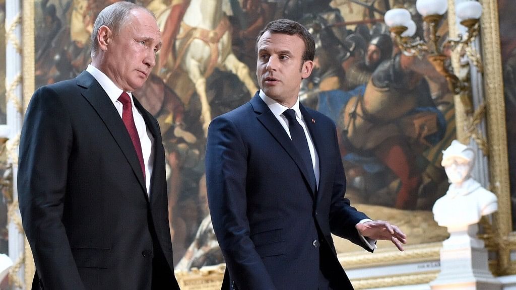 French President Emmanuel Macron, right, speaks to Russian President Vladimir Putin in the Galerie des Batailles (Gallery of Battles) at the Versailles Palace. (Photo: AP)