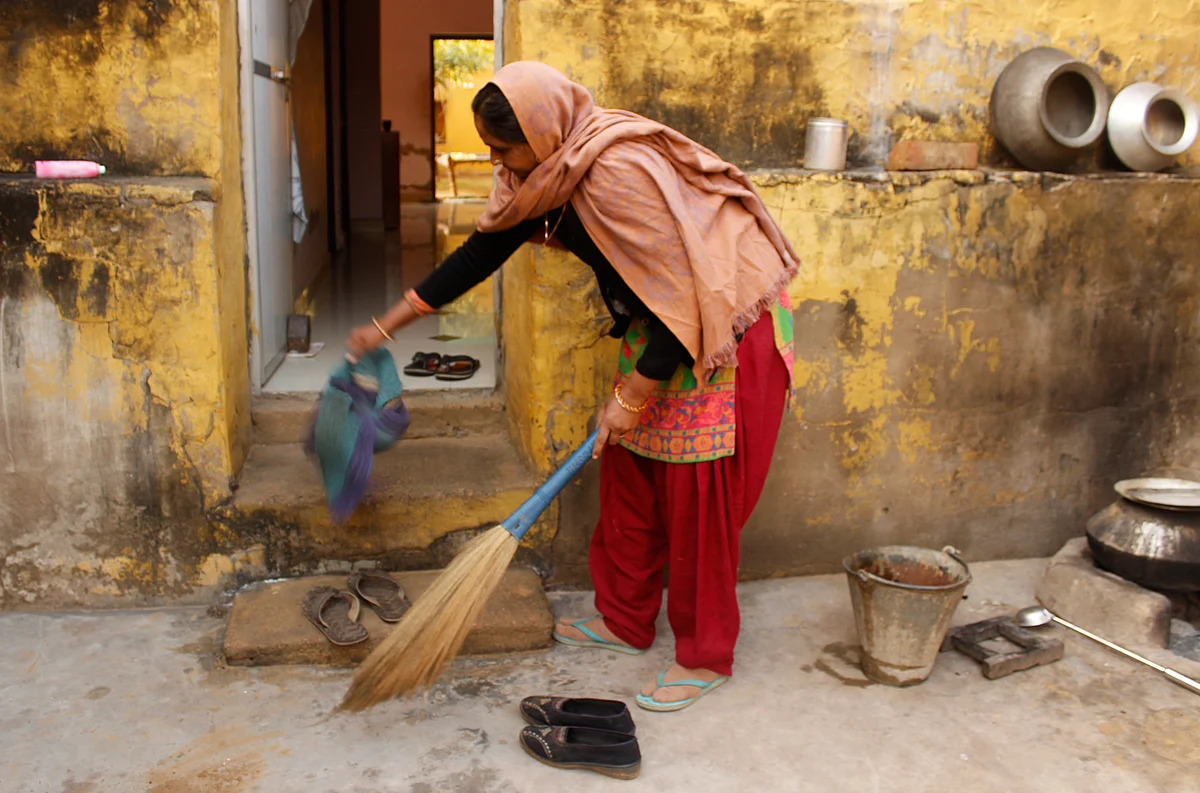 Kavita cleans outside her house in Rewari, a chore set in a daily routine she has grown comfortable with. (Photo: Kashish Badar)