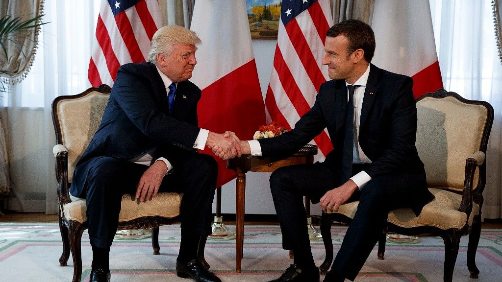 President Donald Trump shakes hands with French President Emmanuel Macron during a meeting at the US Embassy in Brussels. (Photo: AP)